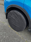 Black spare tire cover on a blue car